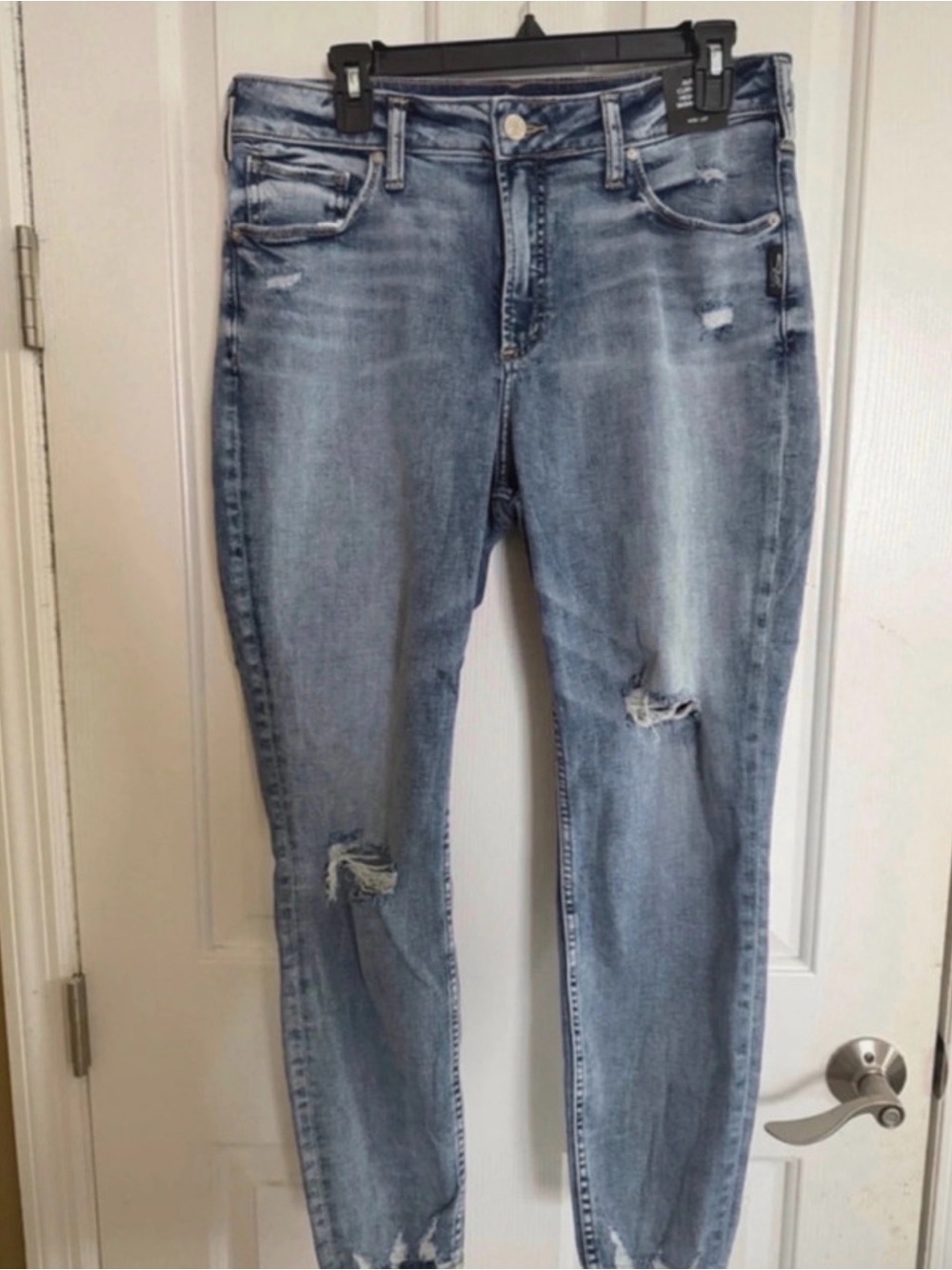 Silver Jeans faded light blue distressed skinny jeans